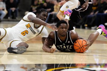 Jan 31, 2026; Columbia, Missouri, USA; Missouri Tigers guard Annor Boateng (6) and Mississippi State Bulldogs guard Josh Hubbard (12) scramble for a loose ball during the first half of the game at Mizzou Arena. Mandatory Credit: Denny Medley-Imagn Images