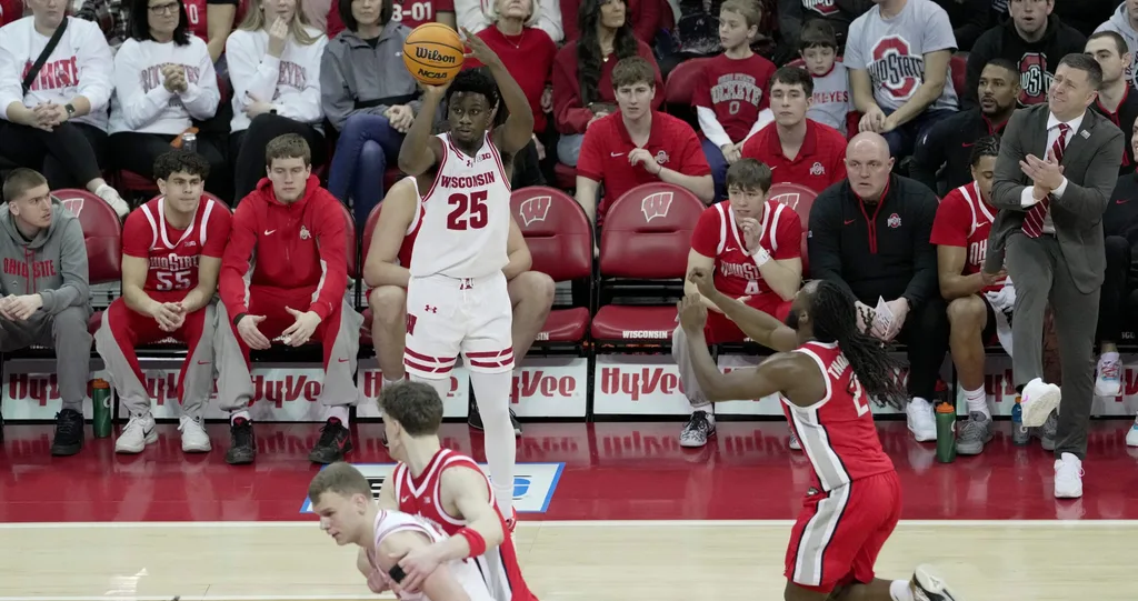 Wisconsin guard John Blackwell (25) hits a three-point basket as Ohio State head coach Jake Diebler looks on during the first half of their game Saturday, January 31, 2026 at the Kohl Center in Madison, Wisconsin.