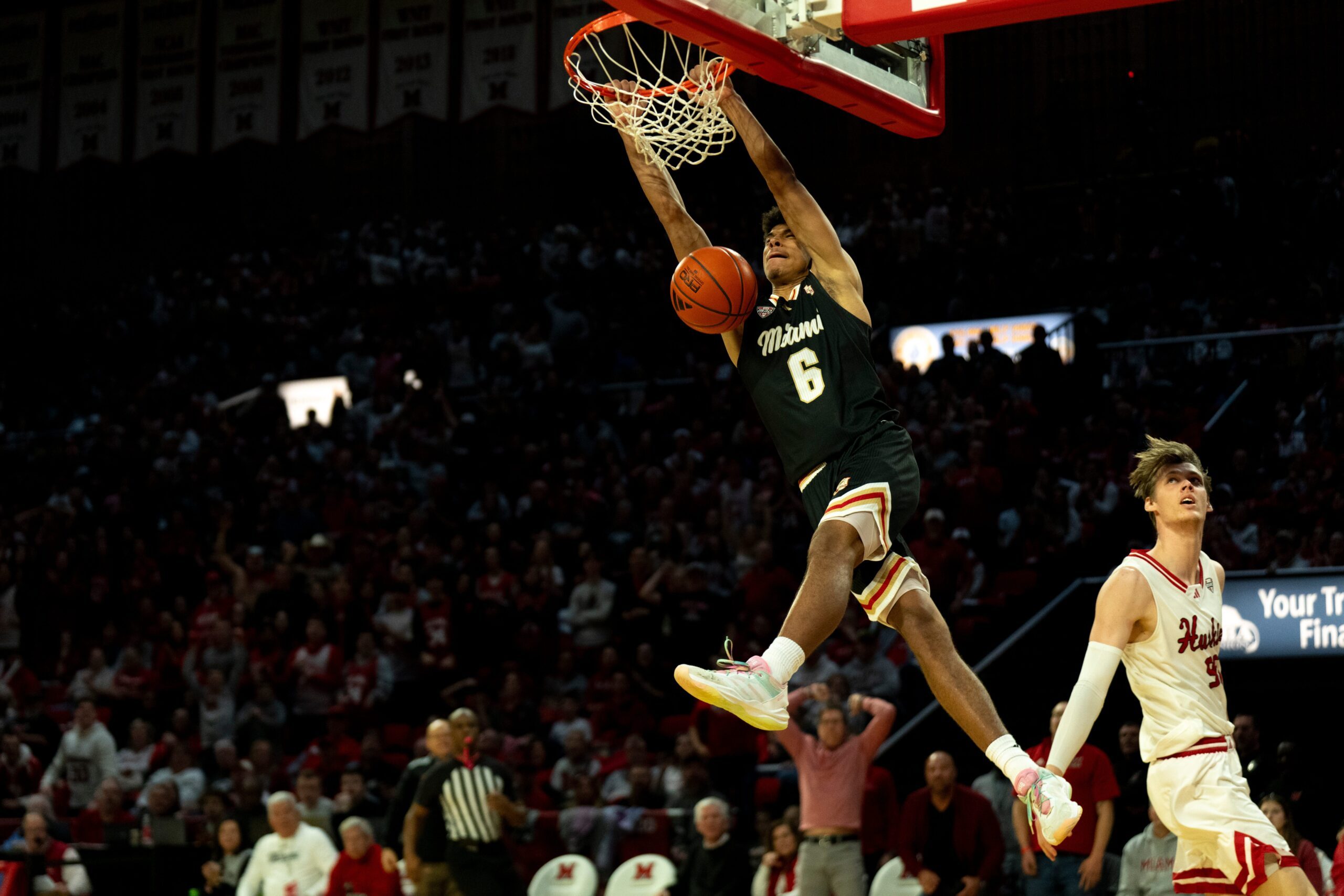 Miami RedHawks guard Justin Kirby (6) dunks on Northern Illinois Huskies forward Gustav Winther (96) defends in the second half of the NCAA Basketball game at Millett Hall in Oxford, Ohio, on Saturday, January 31, 2026.