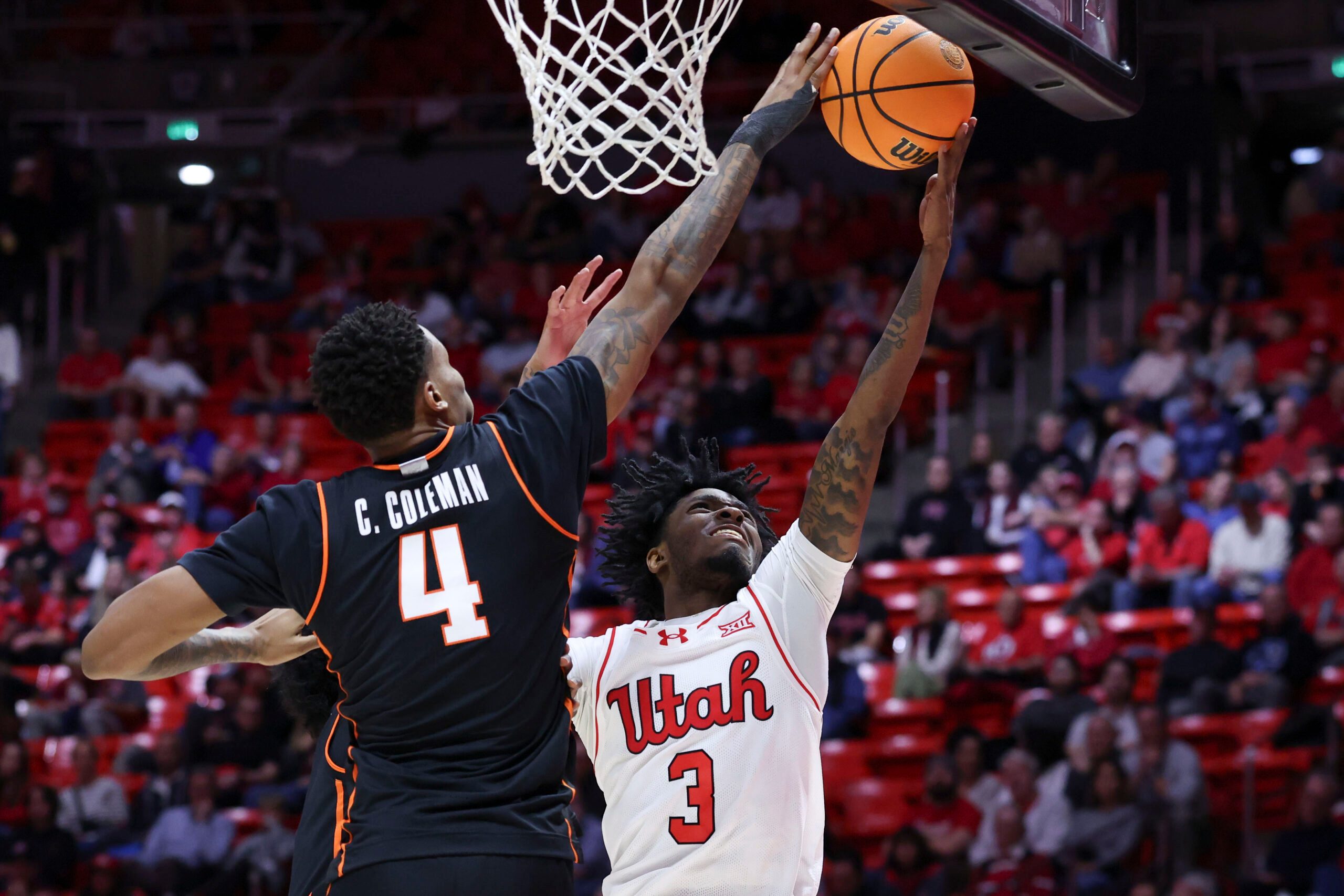 Jan 31, 2026; Salt Lake City, Utah, USA; Oklahoma State Cowboys forward Christian Coleman (4) blocks the shot of Utah Utes guard Don McHenry (3) during the second half at Jon M. Huntsman Center. Mandatory Credit: Rob Gray-Imagn Images