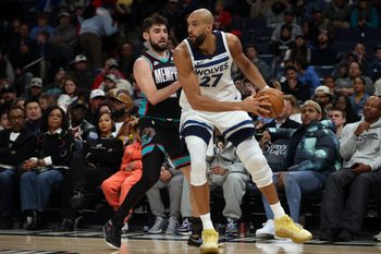 Jan 31, 2026; Memphis, Tennessee, USA; Minnesota Timberwolves center Rudy Gobert (27) handles the ball as Memphis Grizzlies guard Ty Jerome (2) defends during the fourth quarter at FedExForum. Mandatory Credit: Petre Thomas-Imagn Images