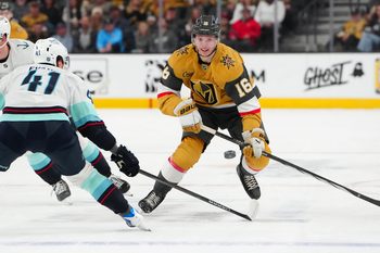 Jan 31, 2026; Las Vegas, Nevada, USA; Vegas Golden Knights right wing Pavel Dorofeyev (16) shoots the puck into the zone beside Seattle Kraken defenseman Ryker Evans (41) during the first period at T-Mobile Arena. Mandatory Credit: Stephen R. Sylvanie-Imagn Images