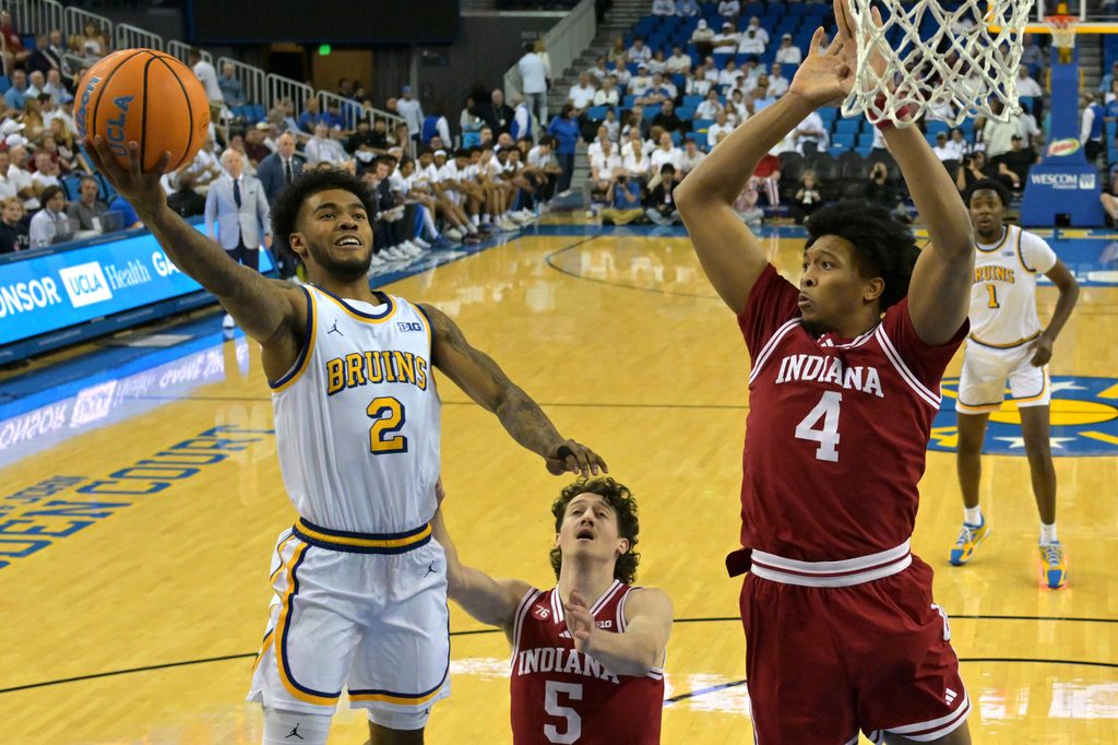 Jan 31, 2026; Los Angeles, California, USA; UCLA Bruins guard Donovan Dent (2) as he drives to the basket past Indiana Hoosiers guard Conor Enright (5) and forward Sam Alexis (4) in the first half at Pauley Pavilion presented by Wescom Financial. Mandatory Credit: Jayne Kamin-Oncea-Imagn Images