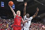 Jan 31, 2026; Spokane, Washington, USA; Saint Mary's Gaels guard Joshua Dent (7) shoots the ball against Gonzaga Bulldogs forward Emmanuel Innocenti (5) in the second half at McCarthey Athletic Center. Gonzaga Bulldogs won 73-65. Mandatory Credit: James Snook-Imagn Images