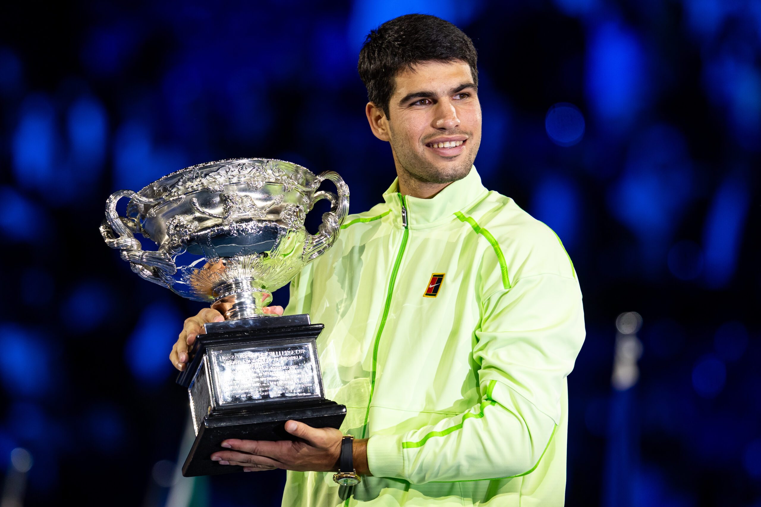 Jan 31, 2026; Melbourne, Victoria, Australia; Carlos Alcaraz of Spain with the Norman Brookes Challenge Cup after his victory over Novak Djokovic of Serbia in the final of the menís singles at the Australian Open at Rod Laver Arena in Melbourne Park. Mandatory Credit: Mike Frey-Imagn Images