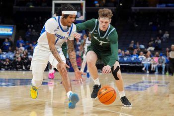 Memphis' Dug McDaniel (1) and Tulane's Rowan Brumbaugh (7) race for the ball during the game between Memphis and Tulane at FedExForum in Memphis, Tenn., on February 1, 2026.