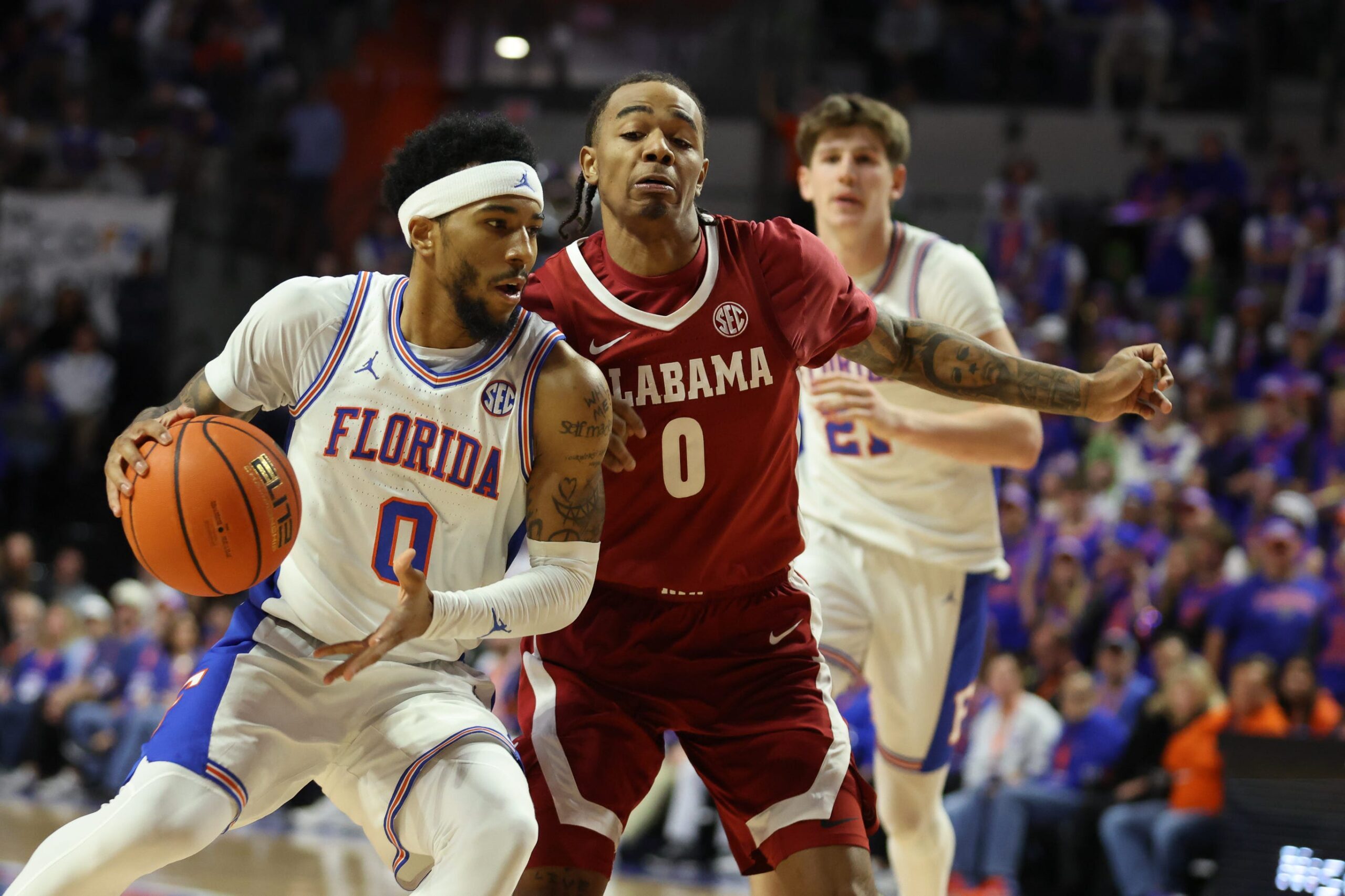 Florida guard Boogie Fland (0) drives against Alabama guard Labaron Philon (0) during the second half of an NCAA Mens basketball game at Steven C. O'Connell Center Exactek arena in Gainesville, FL on Sunday, February 1, 2026. Florida beat Alabama 100-77. [Alan Youngblood/Gainesville Sun]