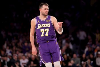 Feb 1, 2026; New York, New York, USA; Los Angeles Lakers guard Luka Doncic (77) points in the direction of Knicks fan Spike Lee (not pictured) after a three point shot against the New York Knicks during the third quarter at Madison Square Garden. Mandatory Credit: Brad Penner-Imagn Images