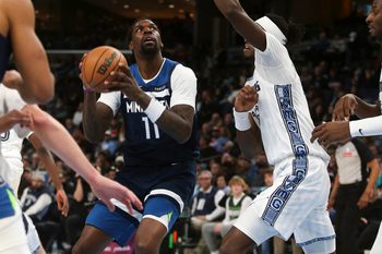 Feb 2, 2026; Memphis, Tennessee, USA; Minnesota Timberwolves center Naz Reid (11) drives to the basket as Memphis Grizzlies forward Olivier-Maxence Prosper (18) defends during the fourth quarter at FedExForum. Mandatory Credit: Petre Thomas-Imagn Images