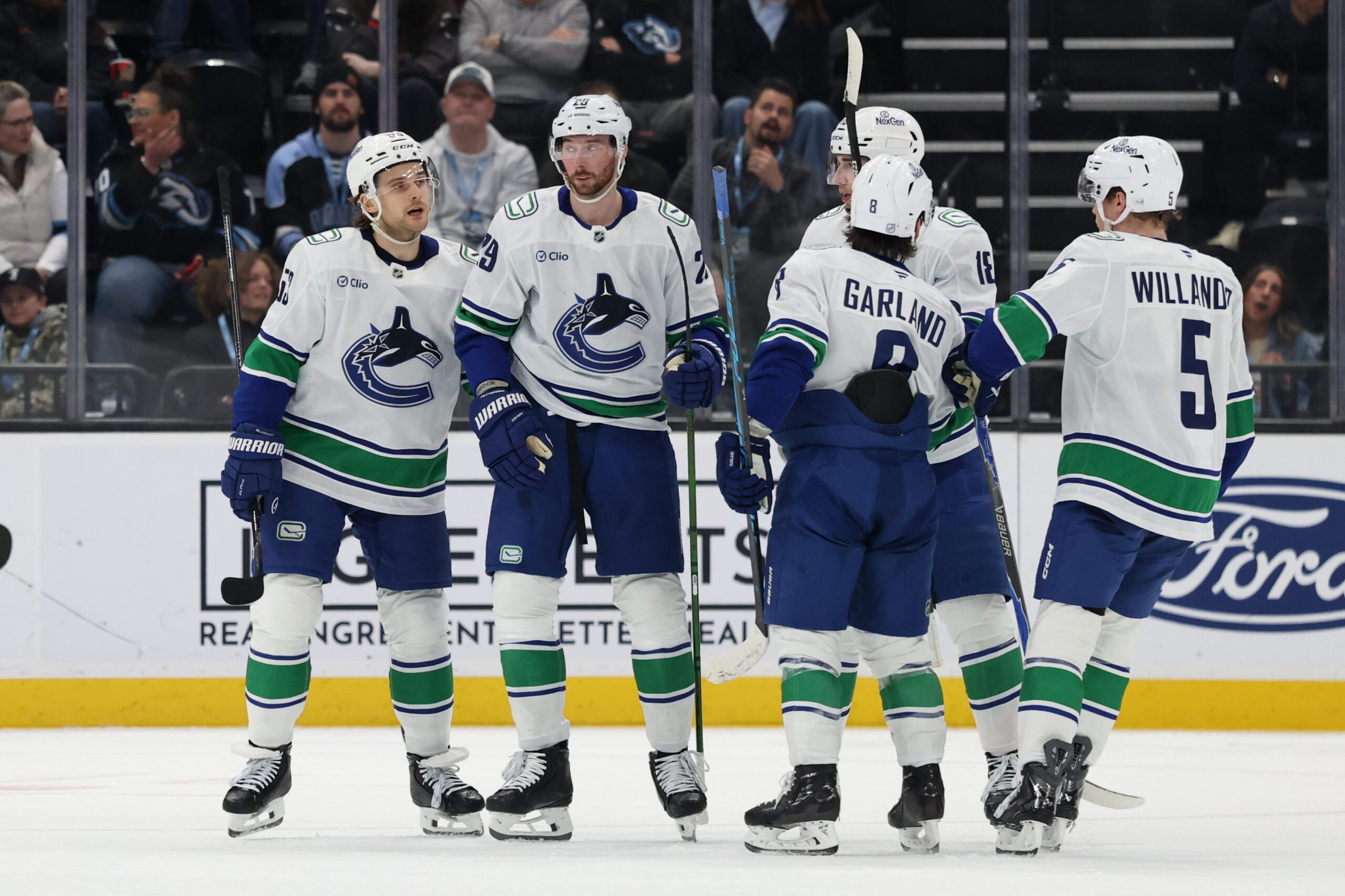 Feb 2, 2026; Salt Lake City, Utah, USA; The Vancouver Canucks celebrate a goal against the Utah Mammoth by Vancouver Canucks center Teddy Blueger (53) during the second period at Delta Center. Mandatory Credit: Rob Gray-Imagn Images