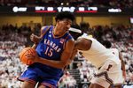 Feb 2, 2026; Lubbock, Texas, USA;  Kansas Jayhawks guard Bryson Tiller (15) drives the ball around Texas Tech Red Raiders guard Tyeree Byran (1) in the second half at United Supermarkets Arena. Mandatory Credit: Michael C. Johnson-Imagn Images