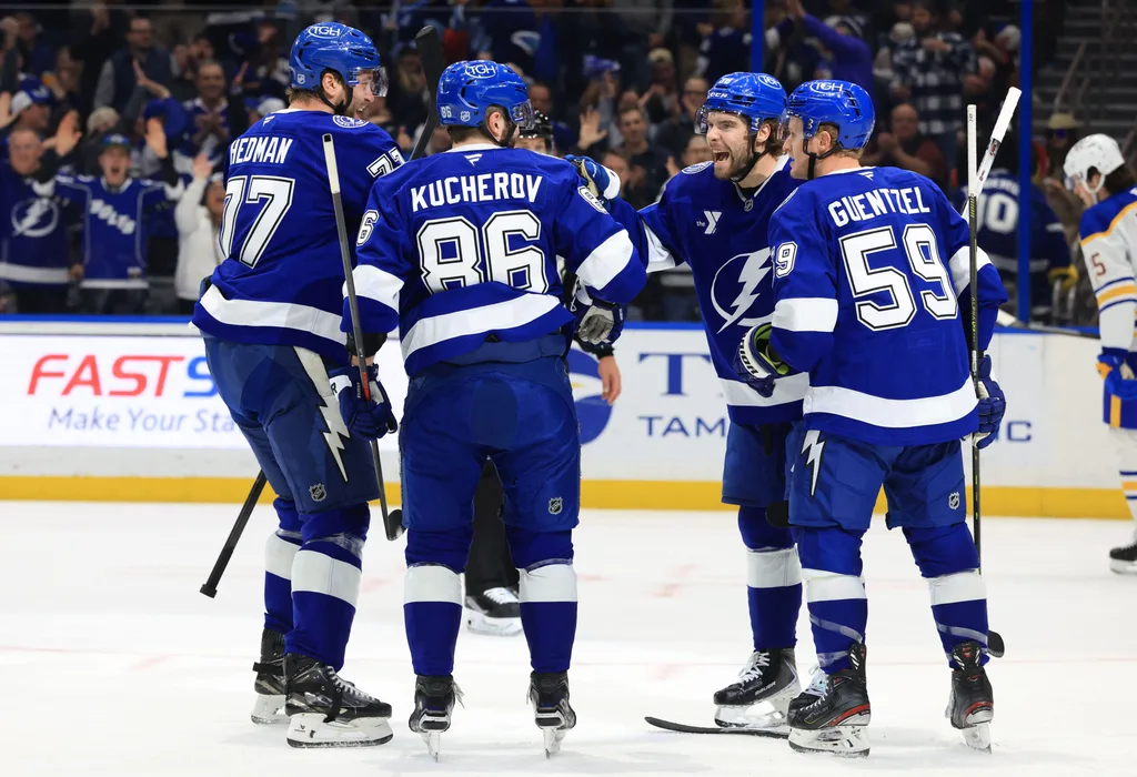 Feb 3, 2026; Tampa, Florida, USA; Tampa Bay Lightning right wing Nikita Kucherov (86) is congratulated by left wing Brandon Hagel (38), defenseman Victor Hedman (77) and center Jake Guentzel (59) after he scored a goal against the Buffalo Sabres during the first period at Benchmark International Arena. Mandatory Credit: Kim Klement Neitzel-Imagn Images