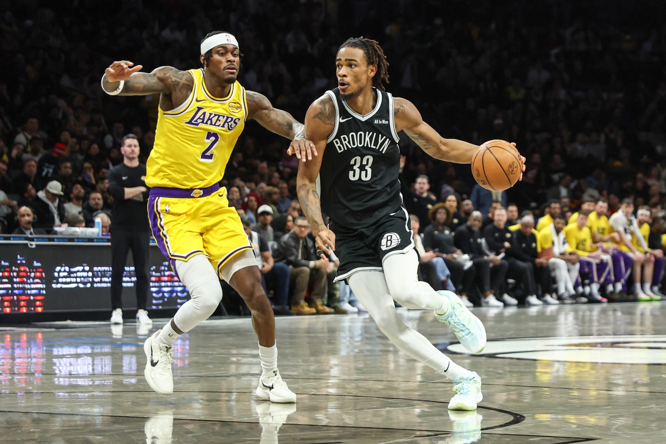 Feb 3, 2026; Brooklyn, New York, USA;  Brooklyn Nets center Nic Claxton (33) drives past Los Angeles Lakers forward Jarred Vanderbilt (2) in the first quarter at Barclays Center. Mandatory Credit: Wendell Cruz-Imagn Images