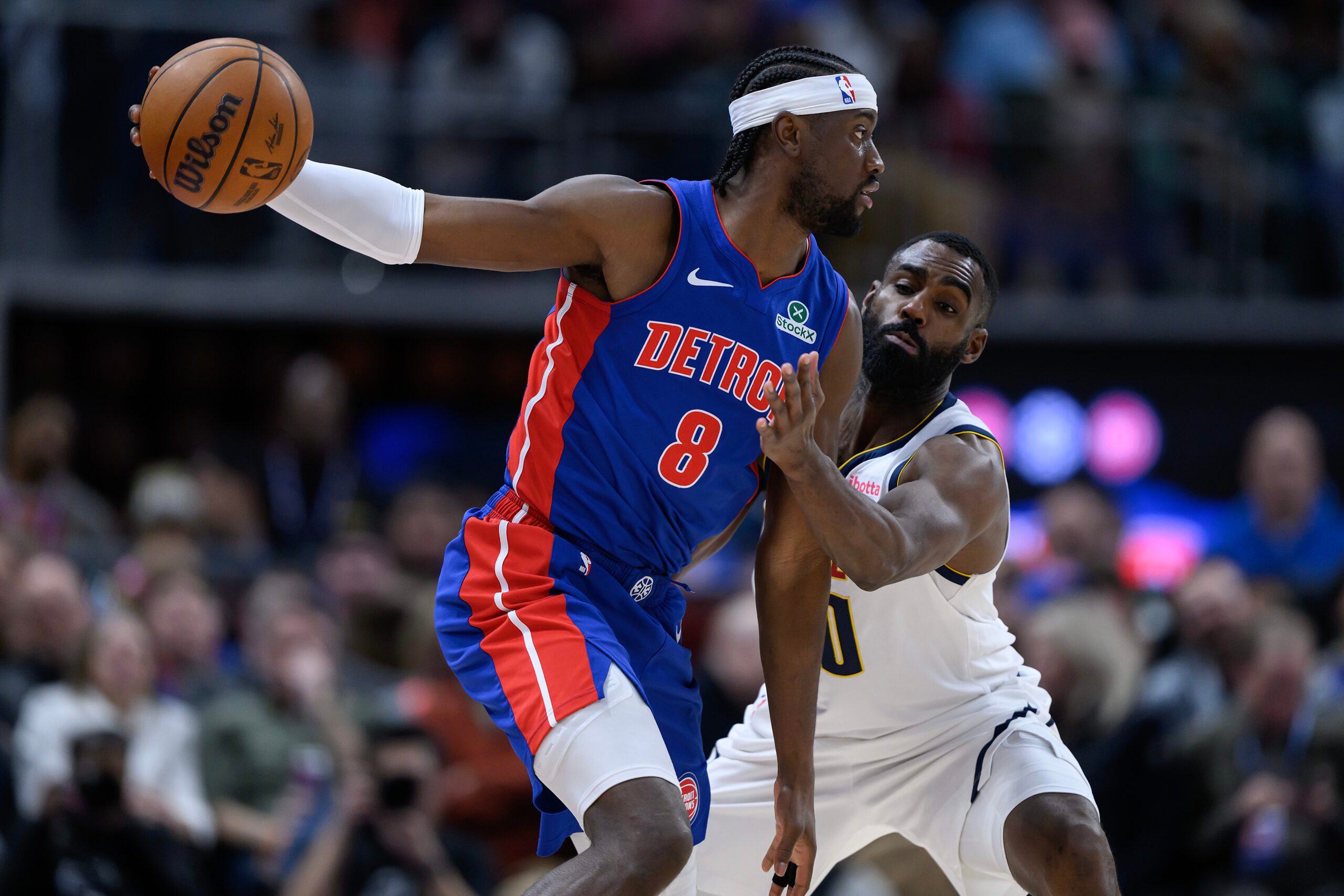 Feb 3, 2026; Detroit, Michigan, USA;  Detroit Pistons guard Caris LeVert (8) tries to keep the ball away from Denver Nuggets guard Tim Hardaway Jr. (10) in the third quarter at Little Caesars Arena. Mandatory Credit: Lon Horwedel-Imagn Images