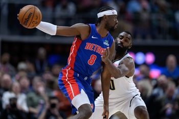 Feb 3, 2026; Detroit, Michigan, USA;  Detroit Pistons guard Caris LeVert (8) tries to keep the ball away from Denver Nuggets guard Tim Hardaway Jr. (10) in the third quarter at Little Caesars Arena. Mandatory Credit: Lon Horwedel-Imagn Images