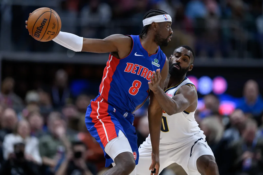 Feb 3, 2026; Detroit, Michigan, USA; Detroit Pistons guard Caris LeVert (8) tries to keep the ball away from Denver Nuggets guard Tim Hardaway Jr. (10) in the third quarter at Little Caesars Arena. Mandatory Credit: Lon Horwedel-Imagn Images