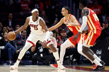 Feb 3, 2026; Miami, Florida, USA;  Atlanta Hawks forward Zaccharie Risacher (10) and forward Mouhamed Gueye (18) defend Miami Heat center Bam Adebayo (13) during the second half at Kaseya Center. Mandatory Credit: Rhona Wise-Imagn Images