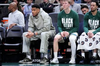 Feb 3, 2026; Milwaukee, Wisconsin, USA; Milwaukee Bucks forward Giannis Antetokounmpo (34), second from left, watches from the bench in the first half against the Chicago Bulls at Fiserv Forum. Mandatory Credit: Michael McLoone-Imagn Images
