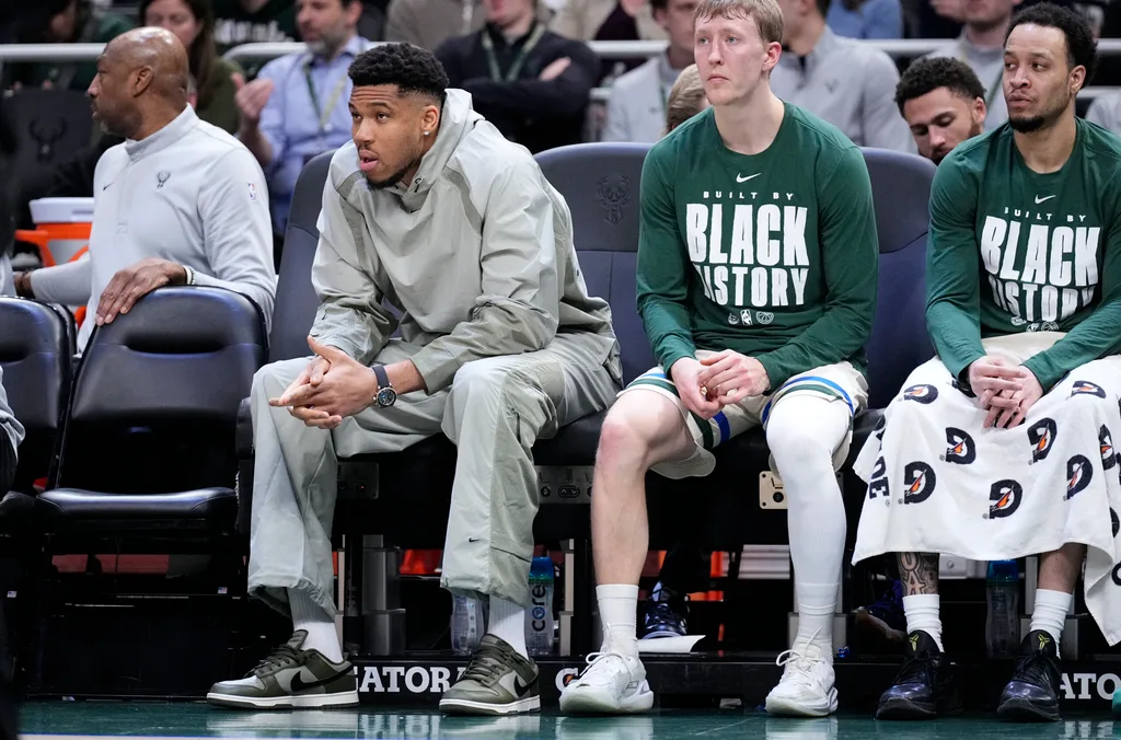 Feb 3, 2026; Milwaukee, Wisconsin, USA; Milwaukee Bucks forward Giannis Antetokounmpo (34), second from left, watches from the bench in the first half against the Chicago Bulls at Fiserv Forum. Mandatory Credit: Michael McLoone-Imagn Images