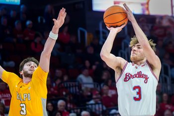 Bradley’s Alex Huibregtse, right, puts up a three-pointer over Valparaiso’s Brody Whitaker in the first half of their college basketball game Tuesday, Feb. 3, 2026 at the Peoria Civic Center. The Braves defeated the Beacons 72-65.
