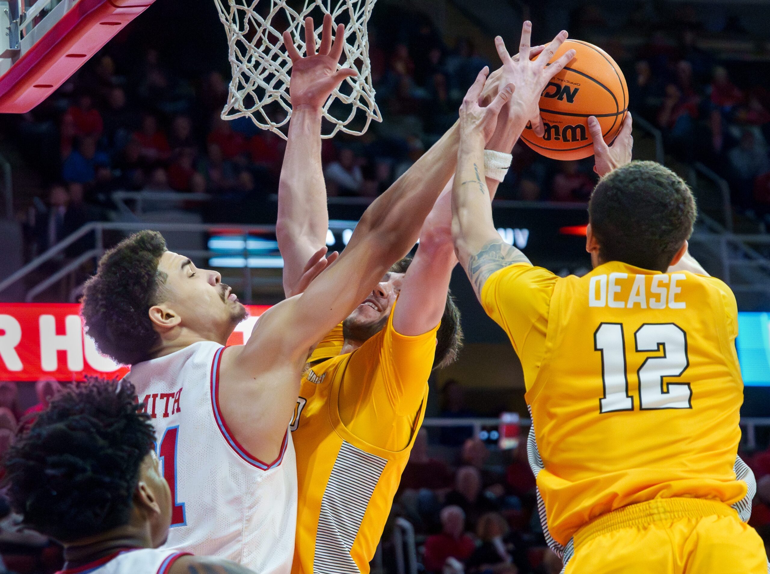 Bradley’s AJ Smith, left, battles for a rebound with Valparaiso’s Owen Dease, right, and Brody Whitaker in the first half of their college basketball game Tuesday, Feb. 3, 2026 at the Peoria Civic Center. The Braves defeated the Beacons 72-65.