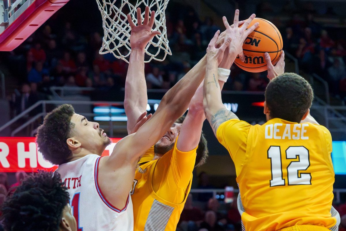 Bradley’s AJ Smith, left, battles for a rebound with Valparaiso’s Owen Dease, right, and Brody Whitaker in the first half of their college basketball game Tuesday, Feb. 3, 2026 at the Peoria Civic Center. The Braves defeated the Beacons 72-65.