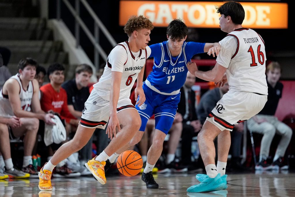 Feb 3, 2026; Davidson, North Carolina, USA; Davidson Wildcats guard Devin Brown (6) handles the ball defended by Saint Louis Billikens forward Brady Dunlap (11) during the second half at McKillop Court at John M. Belk Arena. Mandatory Credit: Jim Dedmon-Imagn Images