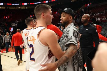 Feb 3, 2026; Portland, Oregon, USA;  Phoenix Suns guard Collin Gillespie (12) is recognized by Portland Trail Blazers guard Damian Lillard (0) after Gillespie scored 30 points in the Suns win over the Portland Trail Blazers at Moda Center. Mandatory Credit: Jaime Valdez-Imagn Images