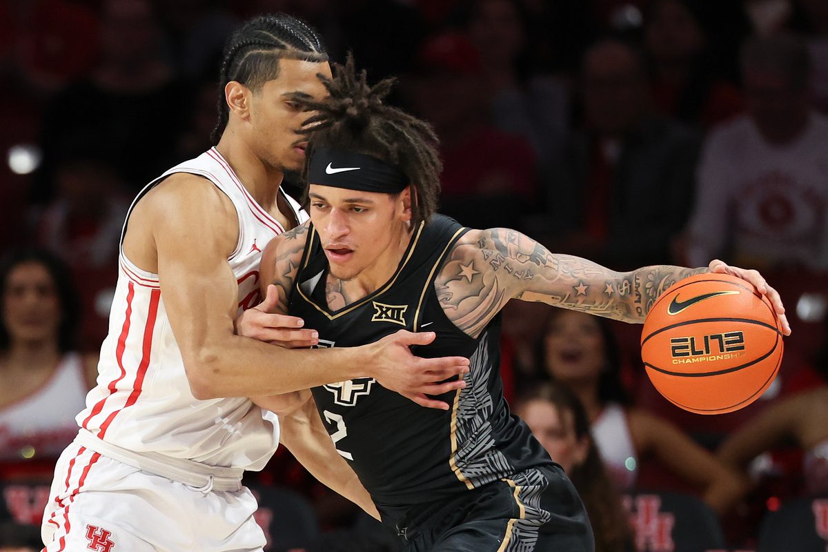 Feb 4, 2026; Houston, Texas, USA;  UCF Knights guard Riley Kugel (2) drives against Houston Cougars guard Milos Uzan (7) in the first half at Fertitta Center. Mandatory Credit: Thomas Shea-Imagn Images