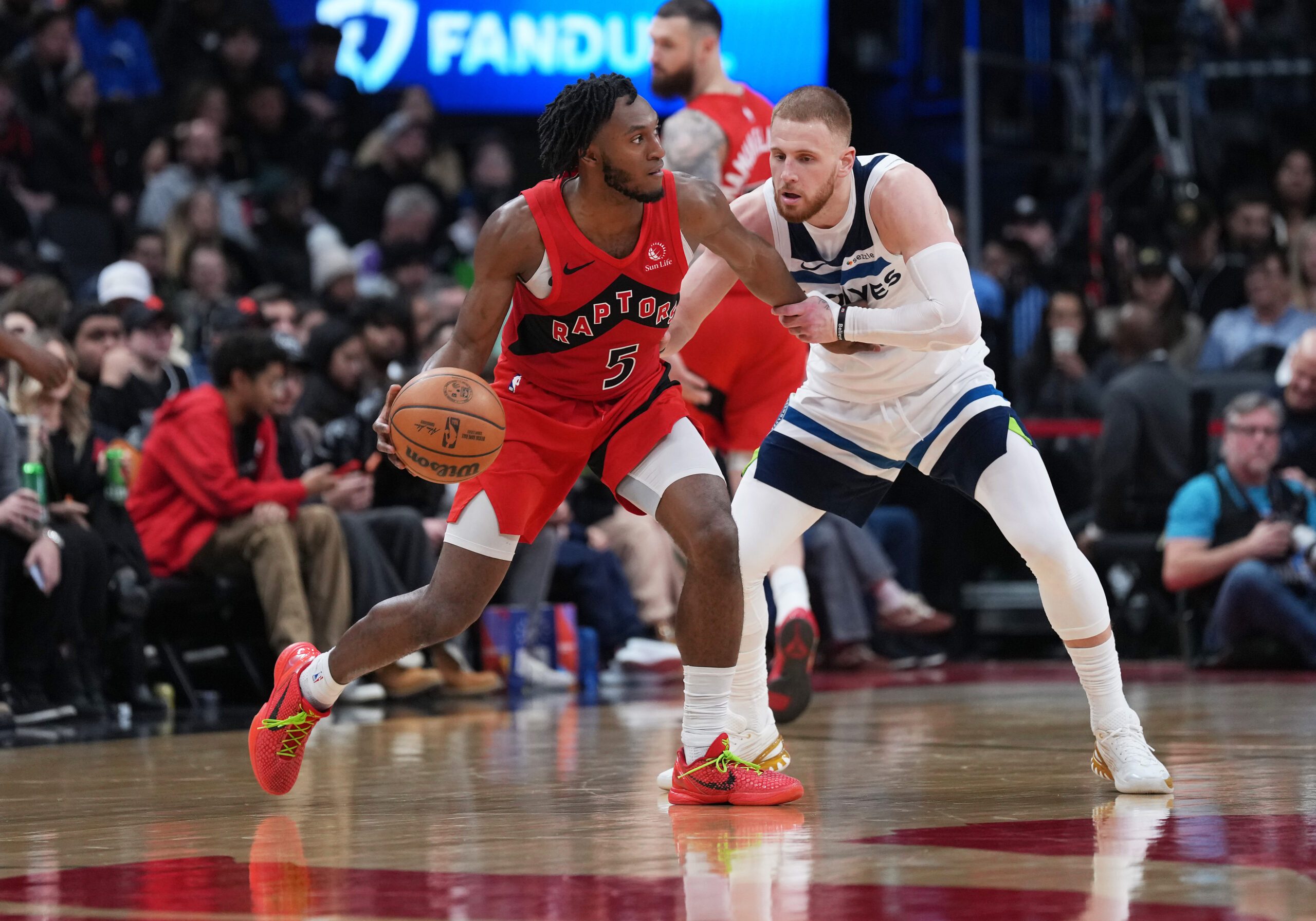 Feb 4, 2026; Toronto, Ontario, CAN; Toronto Raptors guard Immanuel Quickley (5) dribbles against Minnesota Timberwolves guard Donte DiVincenzo (0) during the fourth quarter at Scotiabank Arena. Mandatory Credit: Nick Turchiaro-Imagn Images