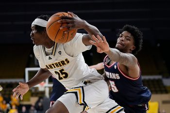 Detroit Mercy Titans guard Orlando Lovejoy (5) attempts to reach for the ball against Milwaukee Panthers forward Sekou Konneh (25) during the second half of the game on Wednesday February 4, 2026 at the UW-Milwaukee Panther Arena in Milwaukee, Wisconsin.