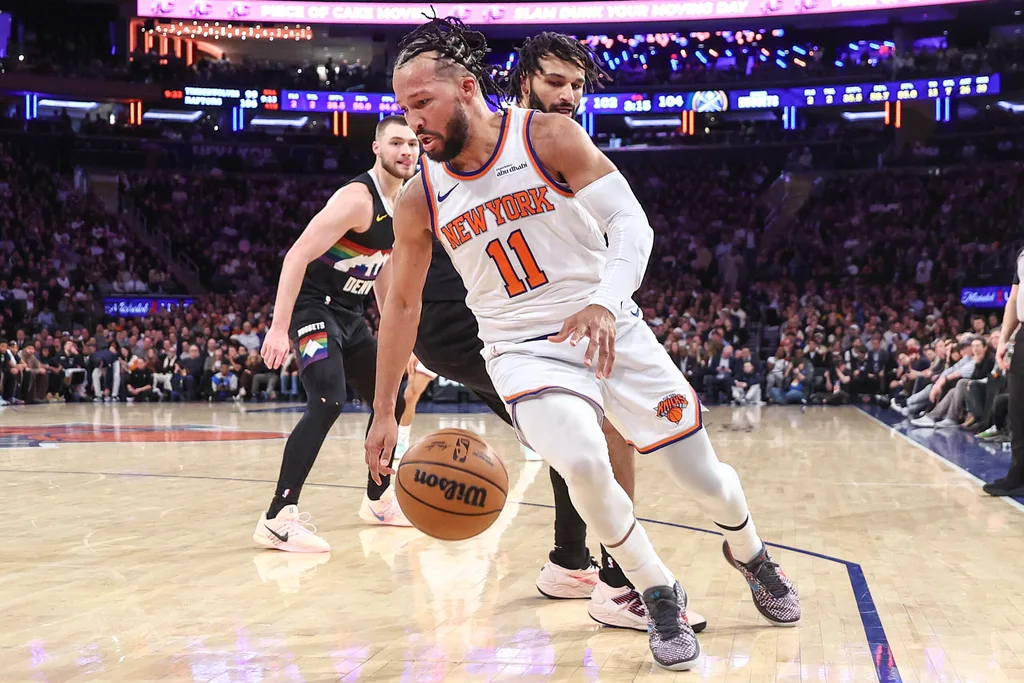Feb 4, 2026; New York, New York, USA; New York Knicks guard Jalen Brunson (11) spins away from Denver Nuggets guard Jamal Murray (27) in the fourth quarter at Madison Square Garden. Mandatory Credit: Wendell Cruz-Imagn Images