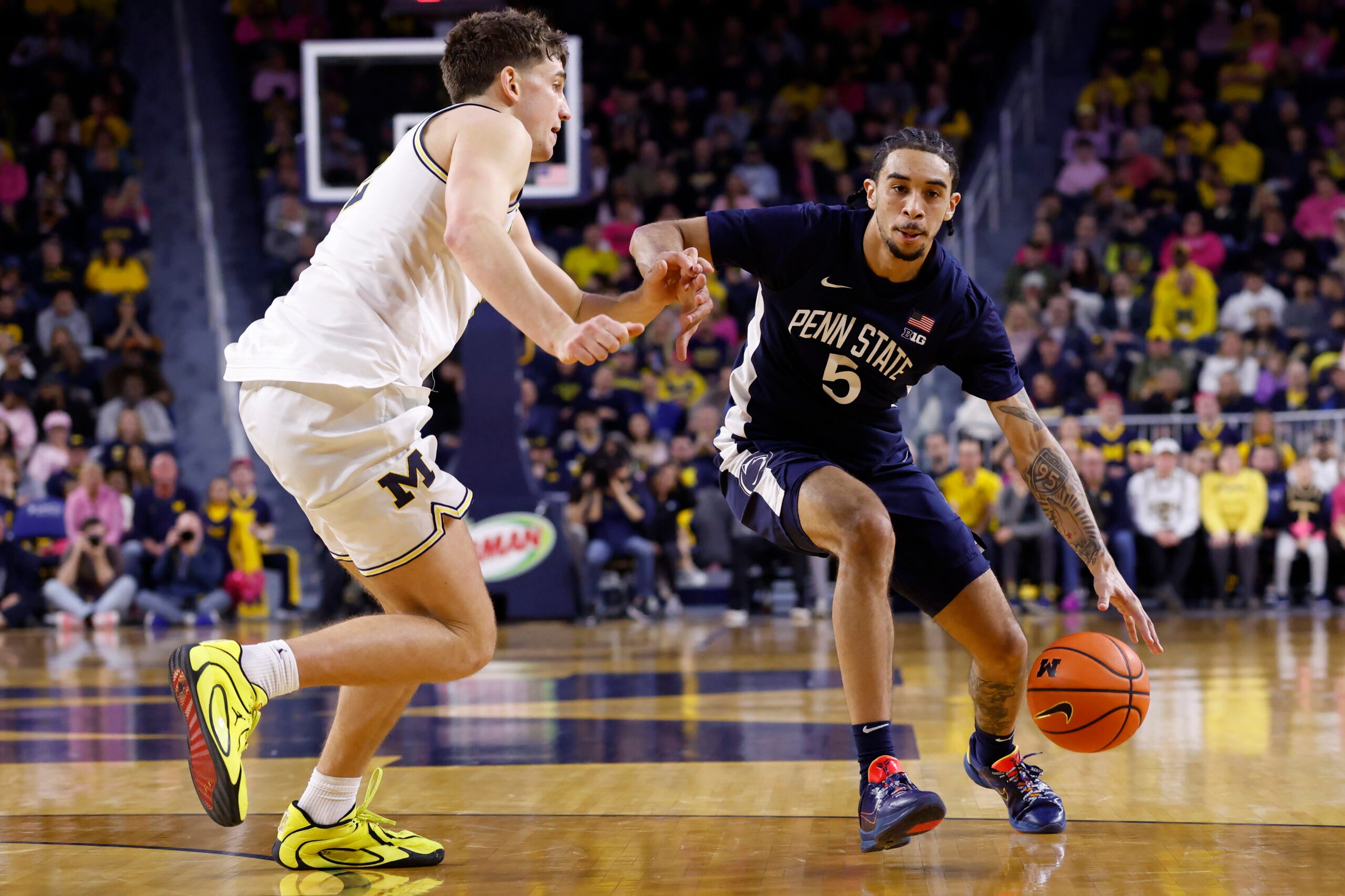 Feb 5, 2026; Ann Arbor, Michigan, USA;  Penn State Nittany Lions guard Freddie Dilione V (5) dribbles against Michigan Wolverines forward Will Tschetter (42) in the second half at Crisler Center. Mandatory Credit: Rick Osentoski-Imagn Images