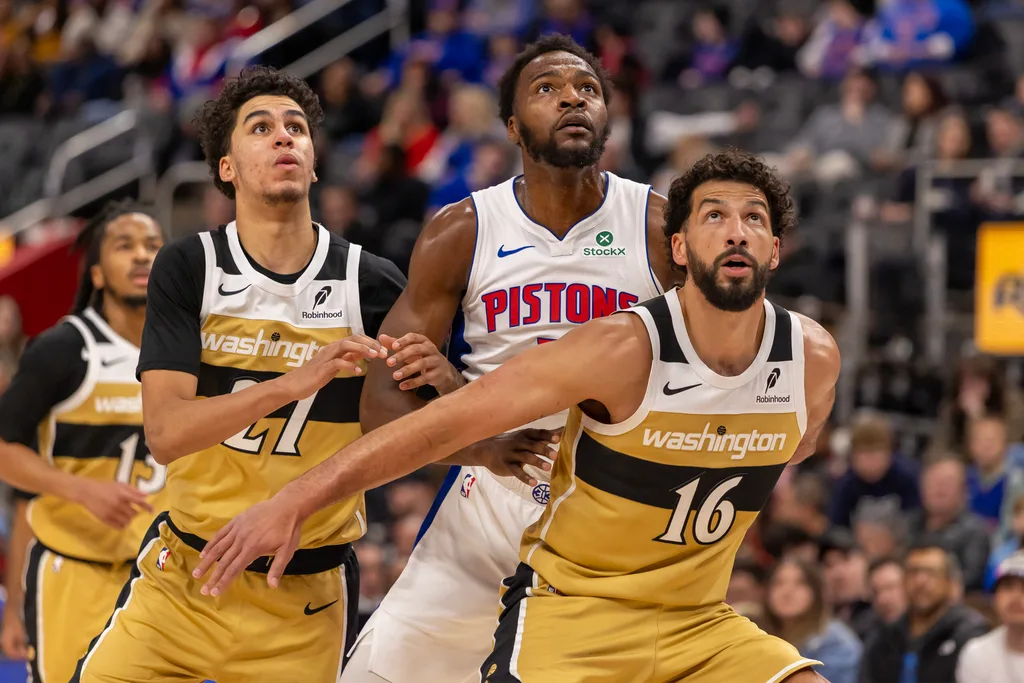 Feb 5, 2026; Detroit, Michigan, USA; Detroit Pistons forward Paul Reed (7) battles for position between Washington Wizards guard Will Riley (27) and forward Anthony Gill (16) during the second half at Little Caesars Arena. Mandatory Credit: David Reginek-Imagn Images