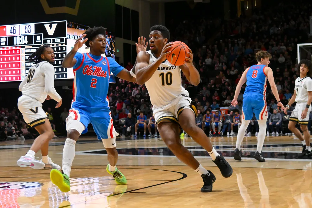 Jan 31, 2026; Nashville, TN, USA; Vanderbilt Commodores forward Ak Okereke (10) drives to the basket past Mississippi Rebels guard AJ Storr (2) during the second half at Memorial Gymnasium. Mandatory Credit: Steve Roberts-Imagn Images