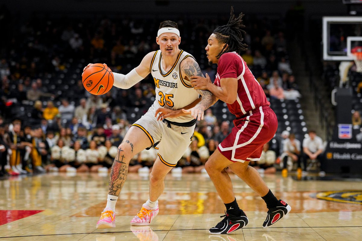 Jan 24, 2026; Columbia, Missouri, USA; Missouri Tigers guard Jacob Crews (35) drives against Oklahoma Sooners guard Nijel Pack (9) during the first half at Mizzou Arena. Mandatory Credit: Jay Biggerstaff-Imagn Images