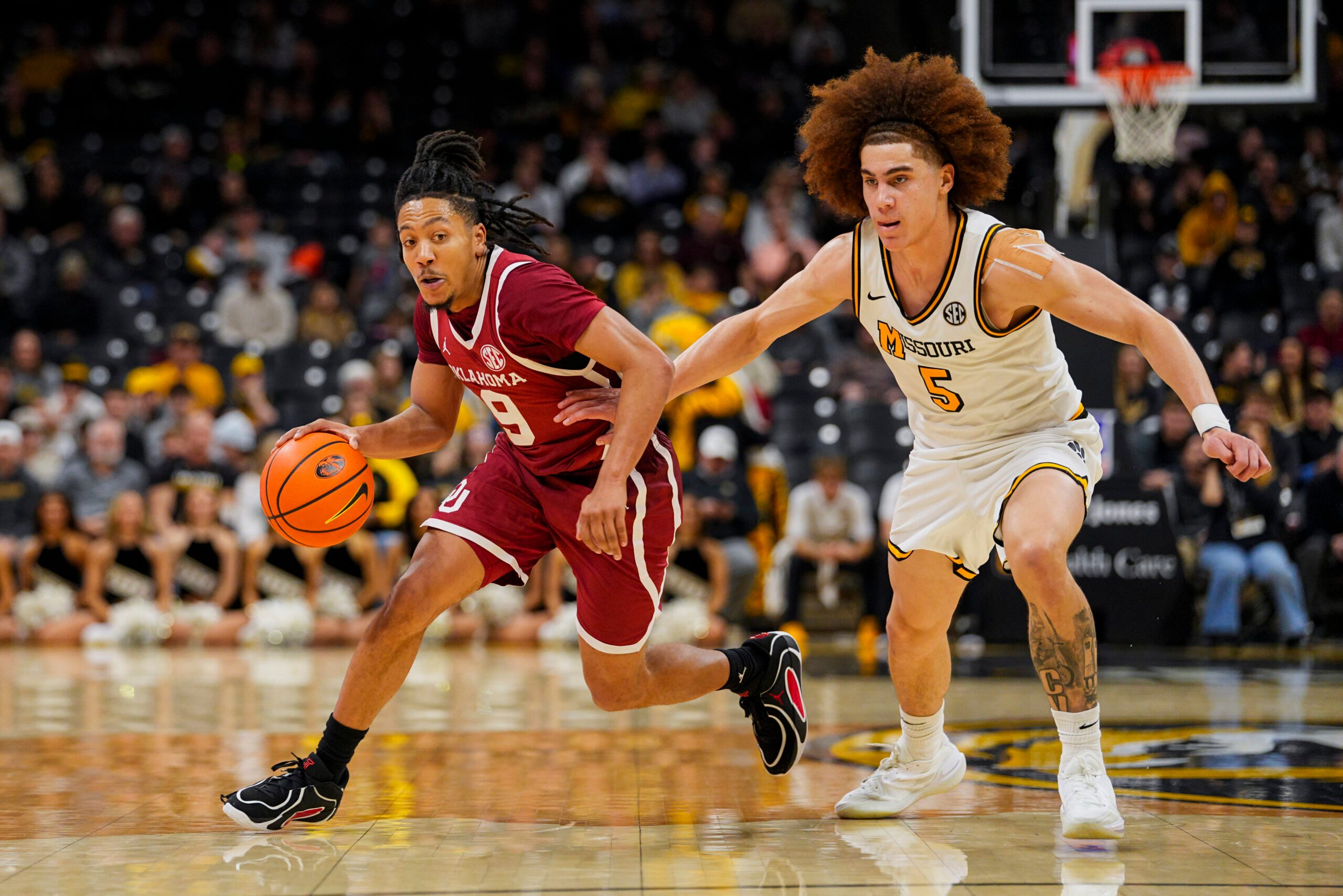 Jan 24, 2026; Columbia, Missouri, USA; Oklahoma Sooners guard Nijel Pack (9) drives against Missouri Tigers guard T.O. Barrett (5) during the second half at Mizzou Arena. Mandatory Credit: Jay Biggerstaff-Imagn Images