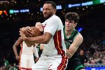 Feb 6, 2026; Boston, Massachusetts, USA;  Miami Heat guard Norman Powell (24) and Boston Celtics guard Hugo Gonzalez (28) battle for the ball during the second half at TD Garden. Mandatory Credit: Bob DeChiara-Imagn Images
