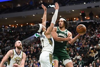 Feb 6, 2026; Milwaukee, Wisconsin, USA; Milwaukee Bucks center Jericho Sims (00) looks to pass the ball away from Indiana Pacers guard Andrew Nembhard (2) in the third quarter at Fiserv Forum. Mandatory Credit: Benny Sieu-Imagn Images