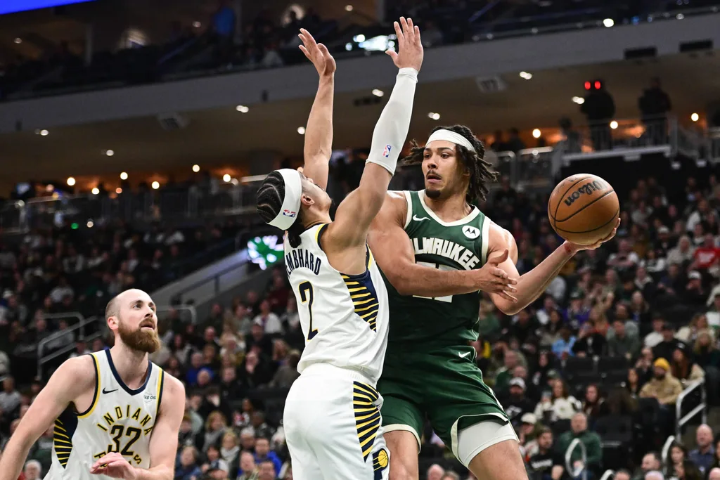 Feb 6, 2026; Milwaukee, Wisconsin, USA; Milwaukee Bucks center Jericho Sims (00) looks to pass the ball away from Indiana Pacers guard Andrew Nembhard (2) in the third quarter at Fiserv Forum. Mandatory Credit: Benny Sieu-Imagn Images