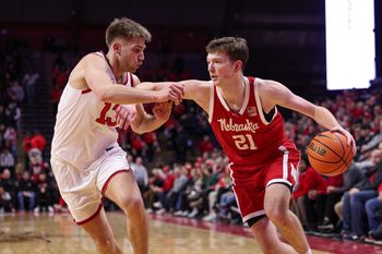 Feb 7, 2026; Piscataway, New Jersey, USA; Nebraska Cornhuskers forward Pryce Sandfort (21) is guarded by Rutgers Scarlet Knights guard Harun Zrno (13) during the first half at Jersey Mike's Arena. Mandatory Credit: Vincent Carchietta-Imagn Images