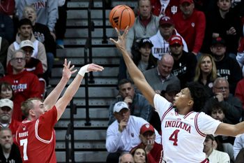Feb 7, 2026; Bloomington, Indiana, USA; Indiana Hoosiers forward Sam Alexis (4) blocks a shot attempt from Wisconsin Badgers guard Andrew Rohde (7) during the first half at Simon Skjodt Assembly Hall. Mandatory Credit: Robert Goddin-Imagn Images