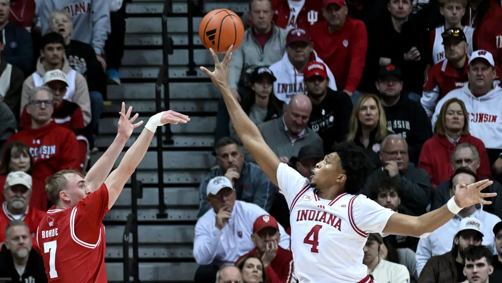 Feb 7, 2026; Bloomington, Indiana, USA; Indiana Hoosiers forward Sam Alexis (4) blocks a shot attempt from Wisconsin Badgers guard Andrew Rohde (7) during the first half at Simon Skjodt Assembly Hall. Mandatory Credit: Robert Goddin-Imagn Images