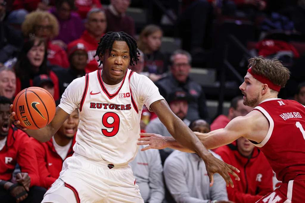 Feb 7, 2026; Piscataway, New Jersey, USA; Rutgers Scarlet Knights forward Dylan Grant (9) is guarded by Nebraska Cornhuskers guard Sam Hoiberg (1) during the second half at Jersey Mike's Arena. Mandatory Credit: Vincent Carchietta-Imagn Images
