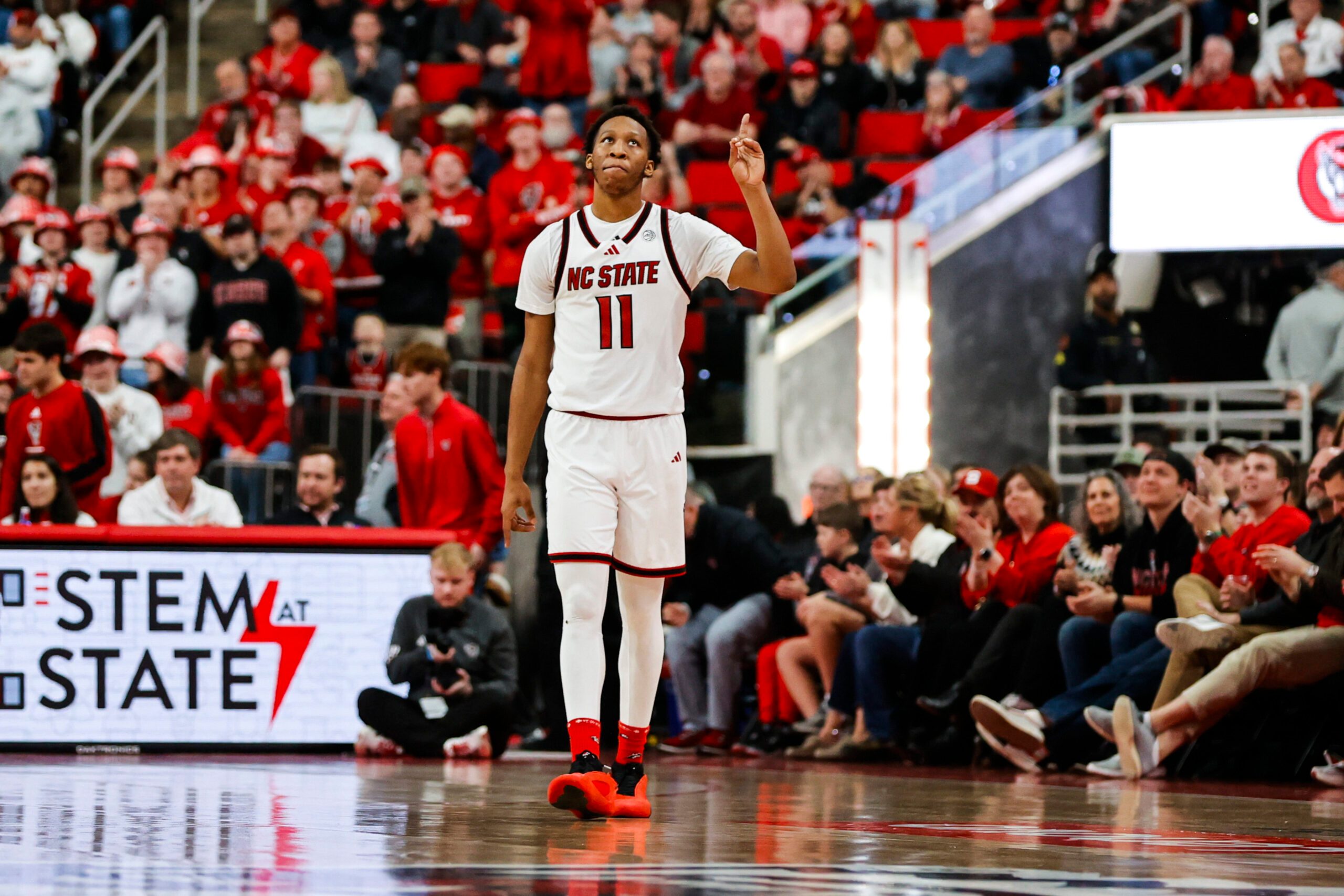 Feb 7, 2026; Raleigh, North Carolina, USA; NC State Wolfpack guard Quadir Copeland (11) reacts to his announcement during the second half of the game against the Virginia Tech Hokies at Lenovo Center. Mandatory Credit: Jaylynn Nash-Imagn Images