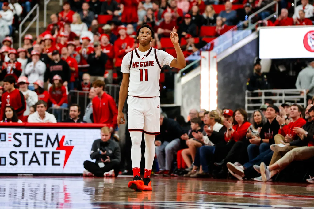 Feb 7, 2026; Raleigh, North Carolina, USA; NC State Wolfpack guard Quadir Copeland (11) reacts to his announcement during the second half of the game against the Virginia Tech Hokies at Lenovo Center. Mandatory Credit: Jaylynn Nash-Imagn Images