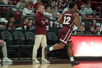 Feb 7, 2026; Starkville, Mississippi, USA; Mississippi State Bulldogs head coach Chris Jans looks on as guard Josh Hubbard (12) dribbles up the court during the first half against the Arkansas Razorbacks at Humphrey Coliseum. Mandatory Credit: Petre Thomas-Imagn Images