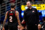 Feb 7, 2026; Lawrence, Kansas, USA; Utah Utes head coach Alex Jensen talks with guard Terrence Brown (2) during the first half against the Utah Utes at Allen Fieldhouse. Mandatory Credit: Jay Biggerstaff-Imagn Images