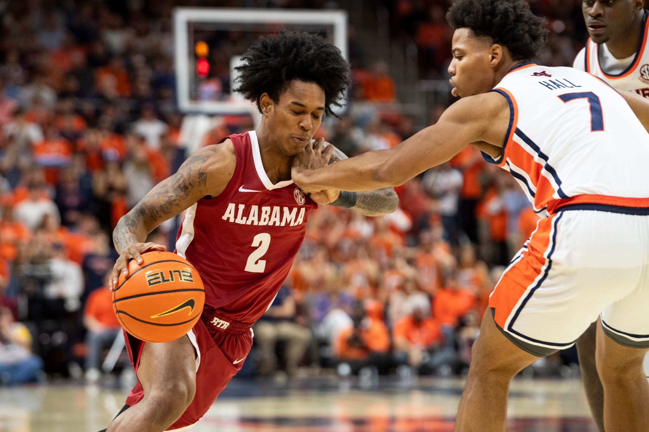 Alabama Crimson Tide guard Aden Holloway (2) drives on Auburn Tigers forward Keyshawn Hall (7) as Auburn Tigers take on Alabama Crimson Tide at Neville Arena in Auburn, Ala. on Saturday, Feb. 7, 2026.
