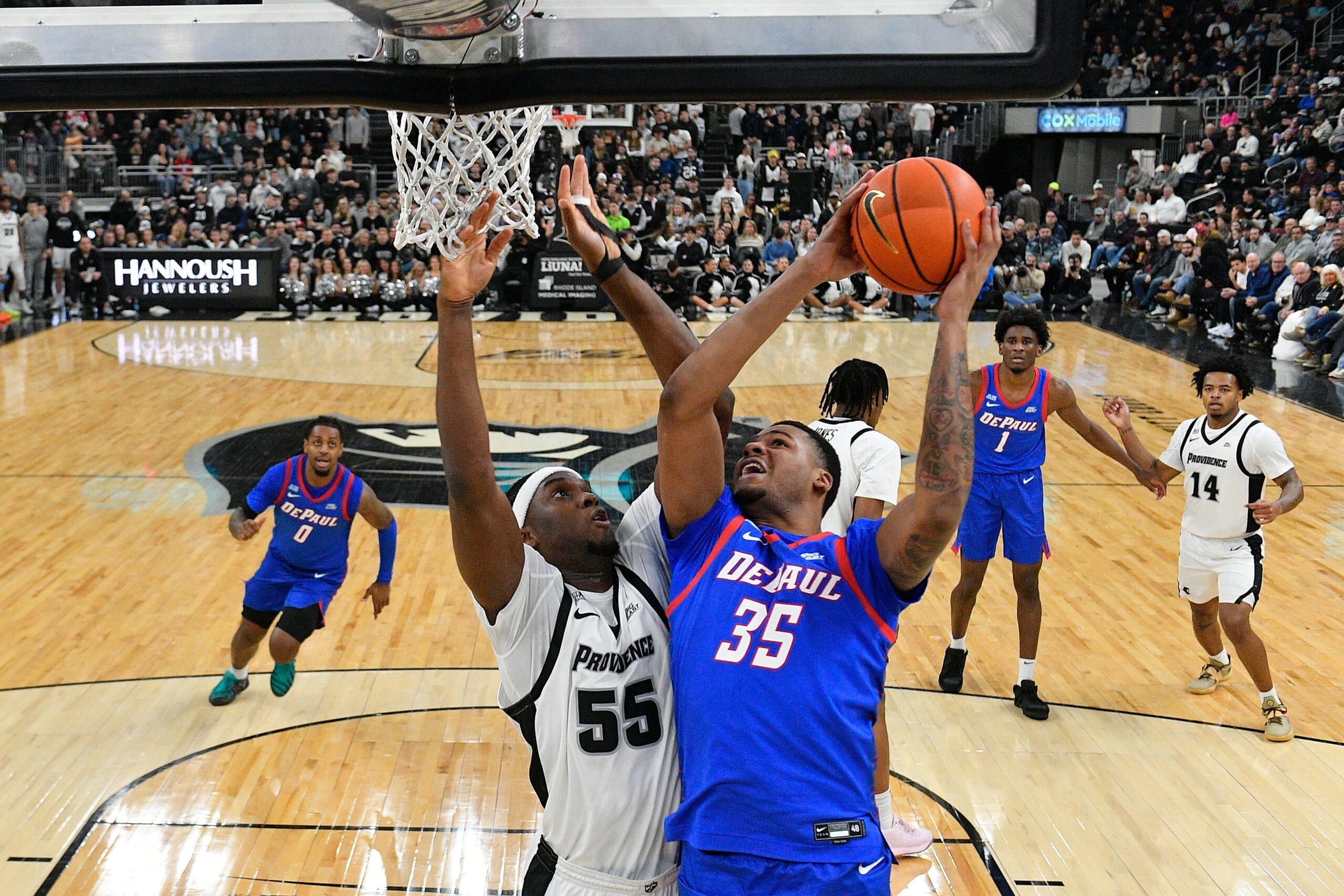 Feb 7, 2026; Providence, Rhode Island, USA; DePaul Blue Demons forward N.J. Benson (35) shoots the ball against Providence Friars forward Oswin Erhunmwunse (55) during the second half at Amica Mutual Pavilion. Mandatory Credit: Eric Canha-Imagn Images